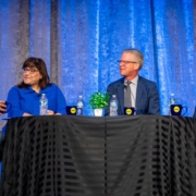 Four panelist discuss the importance of national intermediaries around a kitchen table at the National Rural Housing Conference