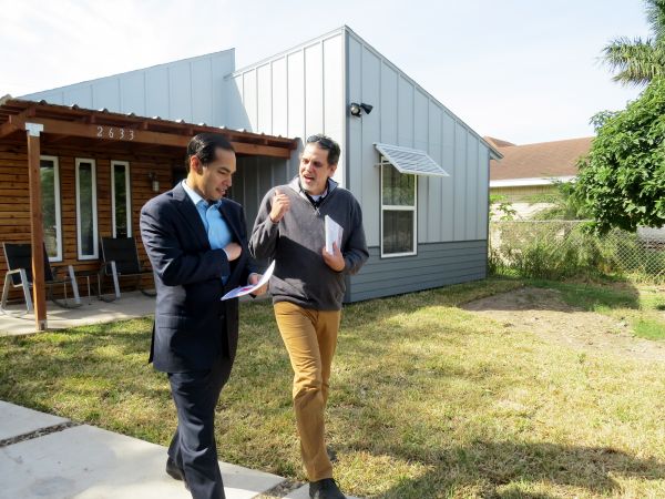 Nick Mitchell-Bennett (right) discusses a project with HUD Secretary Julian Castro