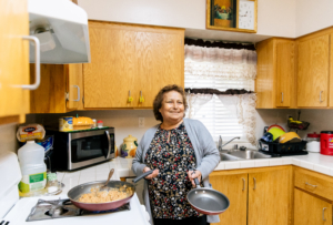 Maria Chavira cooks tortillas, eggs, and beans inside her home