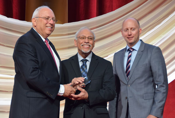 Moises Loza accepts the Housing Visionary Award on behalf of HAC at the 2016 NHC Housing Gala 